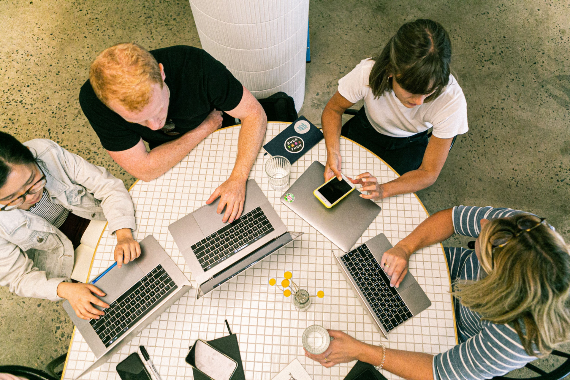 Team working together on laptops around a table